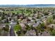 Expansive aerial view of a charming neighborhood nestled among lush trees and greenery, offering serene suburban living at 1792 W Kettle Ave, Littleton, CO 80120