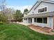 Well-maintained backyard featuring a lush lawn, garden beds, and a cozy patio area great for outdoor relaxation at 1792 W Kettle Ave, Littleton, CO 80120