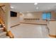 Finished basement with a wet bar, neutral carpet, media center, and staircase at 1792 W Kettle Ave, Littleton, CO 80120