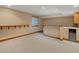 Finished basement with a stylish bar area, complete with a sink, mini-fridge, and a charming window with natural light at 1792 W Kettle Ave, Littleton, CO 80120