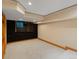 Finished basement with a sleek media center wall unit ideal for cozy movie nights and entertaining guests at 1792 W Kettle Ave, Littleton, CO 80120