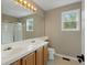 Bathroom featuring double sinks, a shower, and a vanity with wooden cabinets at 1792 W Kettle Ave, Littleton, CO 80120