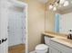 Bright half bathroom features a marble sink, stylish hardware and a wooden floor at 1792 W Kettle Ave, Littleton, CO 80120
