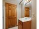 Cozy bathroom featuring a classic vanity with a sink and a framed mirror, alongside a convenient shower stall at 1792 W Kettle Ave, Littleton, CO 80120