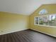 Bedroom featuring vaulted ceiling, a large window, and wood-look flooring at 1792 W Kettle Ave, Littleton, CO 80120