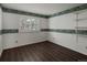 Bright bedroom featuring wood-look floors and light-colored striped wallpaper at 1792 W Kettle Ave, Littleton, CO 80120