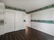 Bedroom with closet, wood-look floors, and light-colored striped wallpaper at 1792 W Kettle Ave, Littleton, CO 80120