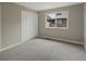 Cozy bedroom with plush carpet, neutral paint, and a bright window to let natural light in at 1792 W Kettle Ave, Littleton, CO 80120