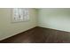 Cozy bedroom with hardwood floors, a shuttered window, and neutral paint at 1792 W Kettle Ave, Littleton, CO 80120