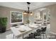 Elegant dining area with modern chandelier, large windows, and seating for six guests at 1792 W Kettle Ave, Littleton, CO 80120