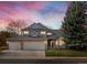Charming two-story home with a well-manicured lawn and three car garage at sunset at 1792 W Kettle Ave, Littleton, CO 80120