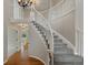 Elegant foyer with a curved staircase, hardwood floors, and a soaring two-story ceiling at 1792 W Kettle Ave, Littleton, CO 80120