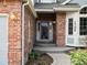 Inviting brick entryway with a charming front door and manicured landscaping and address at 1792 W Kettle Ave, Littleton, CO 80120