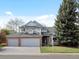 Lovely two-story house with brick accents, a three-car garage, and inviting curb appeal at 1792 W Kettle Ave, Littleton, CO 80120