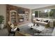 This staged living room features a brick fireplace, built-in bookshelves, and a large picture window at 1792 W Kettle Ave, Littleton, CO 80120