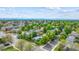 Expansive aerial view of a neighborhood with tree-lined streets and mountain views in the distance at 5007 S Richfield Cir, Aurora, CO 80015