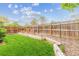 Scenic backyard offers lush lawn, wood fencing and garden beds for ultimate relaxation at 5007 S Richfield Cir, Aurora, CO 80015