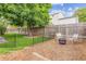Well-maintained yard features wood fence, mature tree, garden and comfortable seating area at 5007 S Richfield Cir, Aurora, CO 80015
