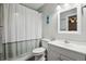 Clean bathroom with shower/tub combo, white vanity, and neutral decor at 5007 S Richfield Cir, Aurora, CO 80015