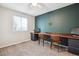 Bedroom with large, built-in wooden desk and carpeted floors at 5007 S Richfield Cir, Aurora, CO 80015
