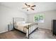 Cozy bedroom with ceiling fan, plush carpet, and large window at 5007 S Richfield Cir, Aurora, CO 80015