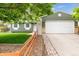 Charming single-story home with a green exterior, a white garage door, and a well-maintained front yard at 5007 S Richfield Cir, Aurora, CO 80015