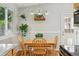 Eat-in kitchen area with wood table, chairs, light fixture and hanging plant at 5007 S Richfield Cir, Aurora, CO 80015