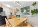 Sunlit eat-in kitchen features light wood cabinets, stainless steel appliances, and hardwood flooring at 5007 S Richfield Cir, Aurora, CO 80015