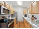 Bright eat-in kitchen with stainless steel appliances, granite countertops, and light wood cabinetry at 5007 S Richfield Cir, Aurora, CO 80015