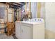 Unfinished laundry area featuring washer, dryer, wooden chairs and storage space at 5007 S Richfield Cir, Aurora, CO 80015
