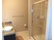 Clean bathroom featuring tiled shower with glass door and granite countertop on vanity at 1441 Central St # 211, Denver, CO 80211