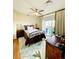 Cozy bedroom featuring a ceiling fan, area rug, and access to the outside at 1441 Central St # 211, Denver, CO 80211