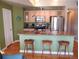 Charming kitchen featuring stainless appliances, a breakfast bar, and ample cabinet space at 1441 Central St # 211, Denver, CO 80211