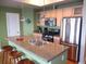 Well-appointed kitchen with stainless appliances, bar seating, and granite countertops at 1441 Central St # 211, Denver, CO 80211