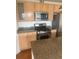 Modern kitchen featuring stainless steel appliances, granite countertops and wood cabinets at 1441 Central St # 211, Denver, CO 80211