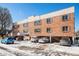 Exterior view of a red brick apartment building with on-site parking at 155 S Pennsylvania St # 308, Denver, CO 80209