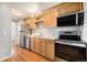 Modern kitchen with stainless steel appliances, wooden cabinets and ample counter space at 155 S Pennsylvania St # 308, Denver, CO 80209