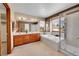 Spacious bathroom with double vanities, soaking tub, glass shower and natural light at 8167 S Dover St, Littleton, CO 80128