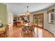 A dining area features wood floors, a table with chairs, and sliding doors to a balcony, complemented by a kitchen view at 8167 S Dover St, Littleton, CO 80128