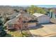 Aerial view of home with a spacious driveway and a large, separate garage at 8167 S Dover St, Littleton, CO 80128