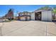 Two-story home with a large driveway and detached garage/storage at 8167 S Dover St, Littleton, CO 80128