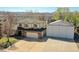 Two-story home featuring a large driveway and detached garage/storage with mountain views at 8167 S Dover St, Littleton, CO 80128