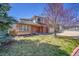 Charming two-story home with a brick and siding facade and well-maintained lawn at 8167 S Dover St, Littleton, CO 80128