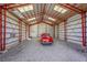 Spacious metal garage with skylights and classic car parked inside at 8167 S Dover St, Littleton, CO 80128