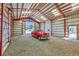 Metal garage with red frame features a classic car parked inside, with an open door at 8167 S Dover St, Littleton, CO 80128
