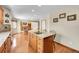 Kitchen island with granite countertop and cooktop, seamlessly blending into the dining and living areas for open concept living at 8167 S Dover St, Littleton, CO 80128