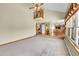 Large living room with high ceilings showing the staircase and kitchen area at 8167 S Dover St, Littleton, CO 80128