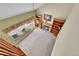 Aerial view of a cozy living room featuring a brick fireplace, built-in bookshelves, and a bright window at 8167 S Dover St, Littleton, CO 80128