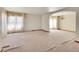 Spacious living room with large windows, plush carpeting, and arched entryways at 8167 S Dover St, Littleton, CO 80128