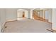 Large living room showing the carpet, walls, archways and entrance to the staircase at 8167 S Dover St, Littleton, CO 80128